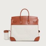 A large black utility tote with mixed canvas and vegan leather panels, multiple cargo pockets, and a silver turn-lock. Additional product view 6.