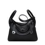 A taupe pebbled vegan leather Lindy bag with side-set handles, a shoulder strap, and silver circular turn-locks. Additional product view 2.