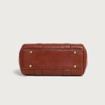 A large cognac brown vegan leather satchel with dual top handles, contrast stitching, and a gold oval turn-lock flap. Additional product view 4.