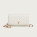 A small black diamond-quilted vegan leather flap bag with a gold flower emblem and a leather-woven gold chain strap. Additional product view 2.