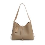 A taupe pebble-grain vegan leather hobo worn on the shoulder, showing gold hardware and a striped interior lining. Additional product view 2.