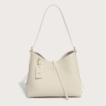 A taupe pebble-grain vegan leather hobo worn on the shoulder, showing gold hardware and a striped interior lining. Additional product view 3.