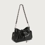 A glossy black crinkled vegan leather underarm bag with snap cargo side pockets, a chain strap, and a small luggage tag. Additional product view 4.