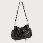 A glossy black crinkled vegan leather underarm bag with snap cargo side pockets, a chain strap, and a small luggage tag.