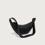 A coffee brown vegan leather croissant bag with vertical ribbed panels, knotted strap joins, and a curved top zipper. Additional product view 3.