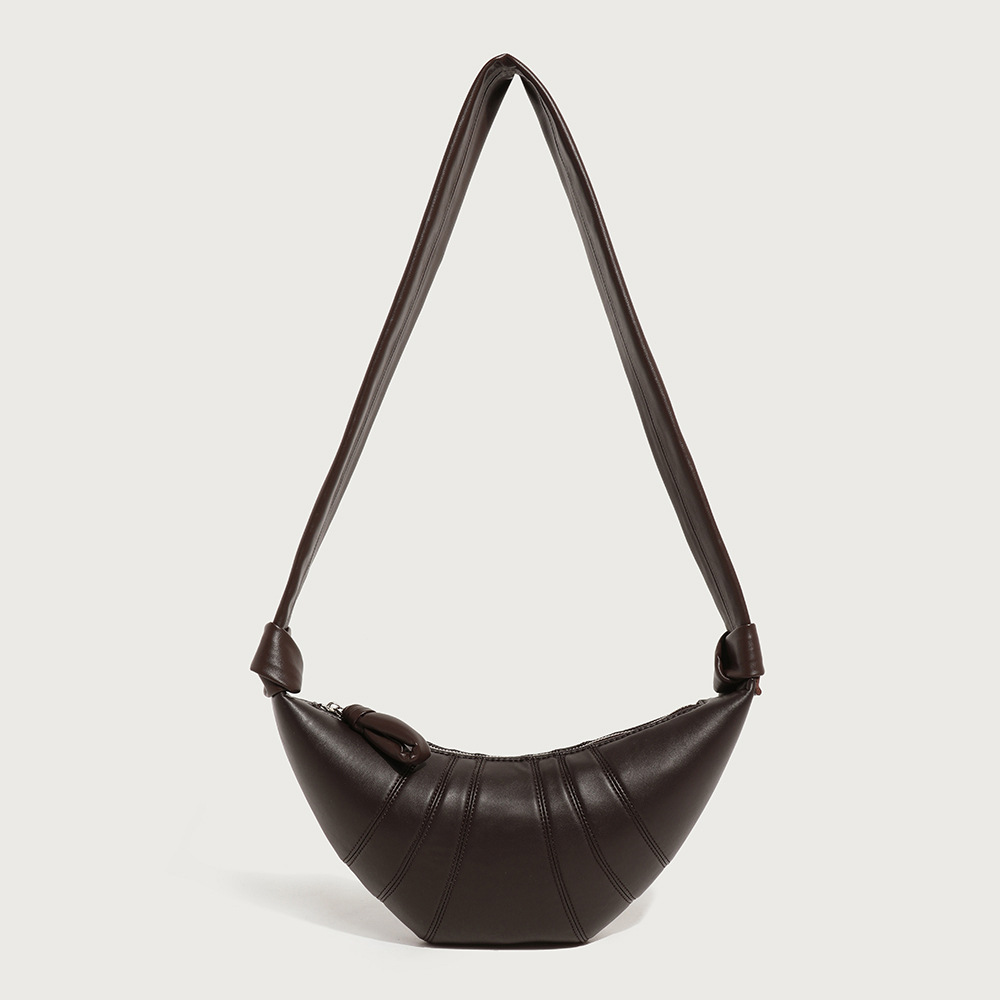 A coffee brown vegan leather croissant bag with vertical ribbed panels, knotted strap joins, and a curved top zipper.