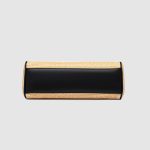A rectangular straw raffia baguette with a black vegan leather flap, gold turn-lock, dual straps, and side leather tassels. Additional product view 5.