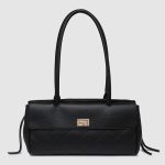 A rectangular straw raffia baguette with a black vegan leather flap, gold turn-lock, dual straps, and side leather tassels. Additional product view 2.