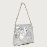 A pastel pink quilted vegan leather pouch with a gathered top, gold chain strap, and a detachable flat crossbody strap. Additional product view 8.