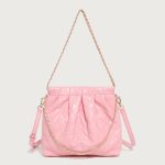 A pastel pink quilted vegan leather pouch with a gathered top, gold chain strap, and a detachable flat crossbody strap.