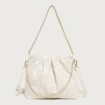 A pastel pink quilted vegan leather pouch with a gathered top, gold chain strap, and a detachable flat crossbody strap. Additional product view 3.