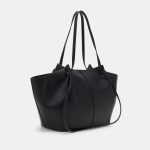 A large black vegan leather flared tote with long shoulder straps and a gold turn-lock on a slim horizontal strap. Additional product view 3.