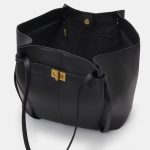 A large black vegan leather flared tote with long shoulder straps and a gold turn-lock on a slim horizontal strap. Additional product view 4.