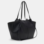 A large black vegan leather flared tote with long shoulder straps and a gold turn-lock on a slim horizontal strap. Additional product view 2.