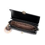 A black vegan leather flap handbag with a quilted lower panel, gold oval clasp, top handle, and a tan furry bag charm. Additional product view 4.