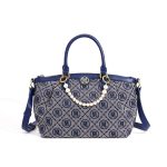 A navy and gray monogram jacquard tote with vegan leather trim, gold hardware, dual handles, and a faux pearl chain. Additional product view 4.