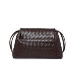 A black woven vegan leather shoulder bag with a large fold-over flap and thin tubular straps on a white background. Additional product view 6.