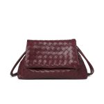 A black woven vegan leather shoulder bag with a large fold-over flap and thin tubular straps on a white background. Additional product view 3.