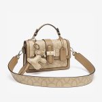 A beige and tan monogram satchel with a top handle, gold buckle, teddy-bear charm, and two detachable shoulder straps. Additional product view 4.