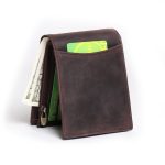 A vintage brown distressed leather bifold wallet standing upright with an outer card slot, zip coin pocket, and cash compartment. Additional product view 6.
