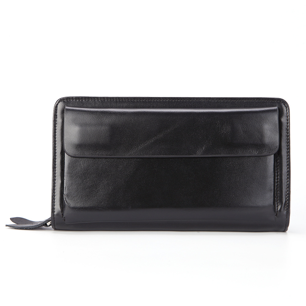 A black top-grain leather long wallet with a front flap, zip-around closure, and leather zipper pull on a white background.