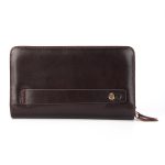A black top-grain leather long wallet with a front flap, zip-around closure, and leather zipper pull on a white background. Additional product view 3.